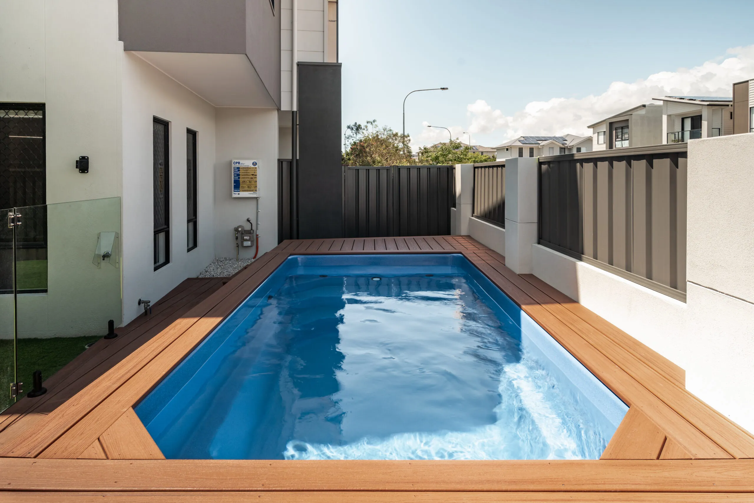 Fibreglass plunge pool with timber surround in a townhouse courtyard